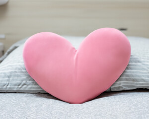 Blank heart shaped pillow on the bed MADE OF AI
