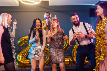 Group of people dancing in the club celebrating New Years