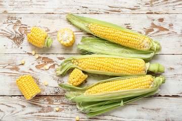 Fresh corn cobs on weathered wooden table