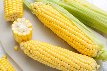 Board with fresh corn cobs, closeup