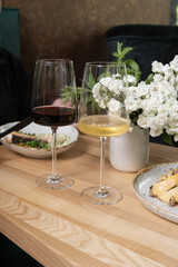 Two wineglasses with red and white wine at a restaurant table