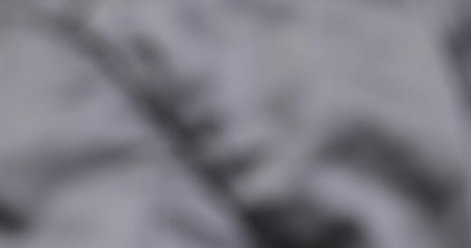 crumpled gray material in close-up, part of the fabric from gray-tinged clothing