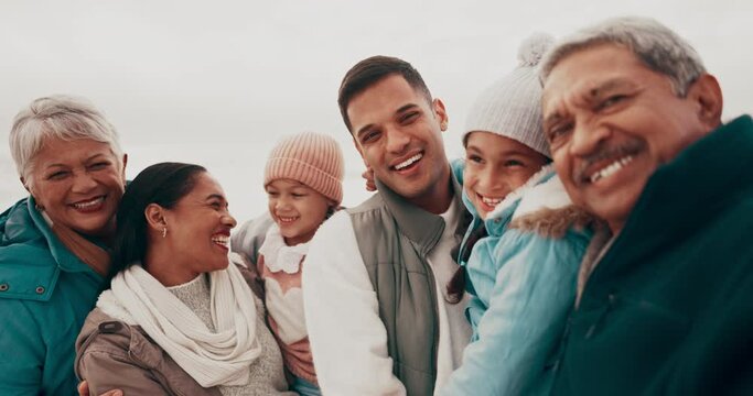 Travel, happy and face of a big family on beach while on a winter vacation, adventure or holiday. Happiness, smile and portrait of children by ocean with grandparents and parents on a weekend trip.