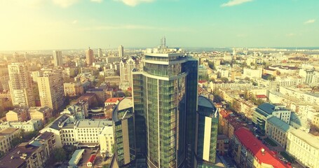 Aerial Drone Flight: Picturesque view on cityscape with glass business center in sunset light. Flight over the Boulevard of Taras Shevchenko, Kiev, Ukraine, Europe.