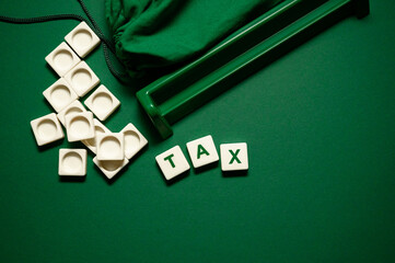 the word taxes on a green background. taxes consists of letters. inscription taxes