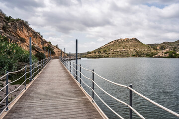 Footbridge in the Elche reservoir. In this footbridge you can see the nature of the environment. In Elche, Alicante, Valencian community, Spain