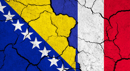 Flags of Bosnia and France on cracked surface - politics, relationship concept