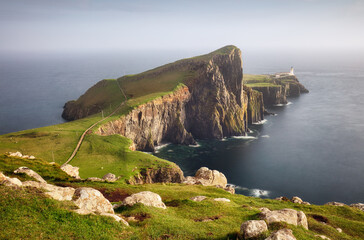 A view of the Neist Point Lighthouse on the green cliffs of the Isle of Skye