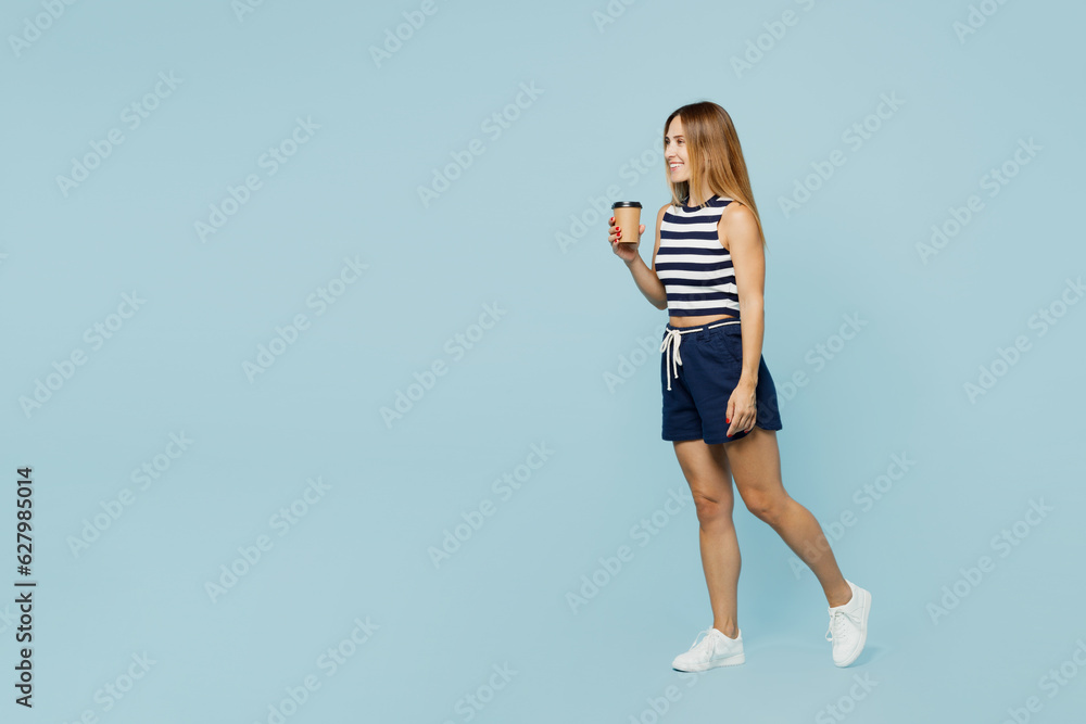 Sticker Full body young woman she wear striped tank shirt casual clothes hold takeaway delivery craft paper brown cup coffee to go isolated on plain pastel light blue cyan background studio Lifestyle concept