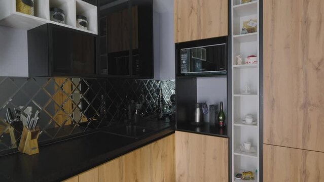 Modern kitchen in a small apartment. Kitchen interior with modern and comfortable equipment.