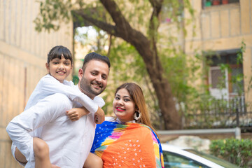 Fototapeta premium indian family standing outdoor and giving happy expression.