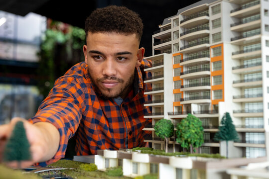 Biracial male architect working on a building model at office