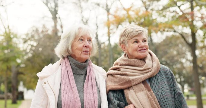 Senior, women and friends in a park bond, walking and enjoying conversation outdoor together. Elderly, ladies and happy, walk and talking in in a forest on weekend, relax and having fun in nature