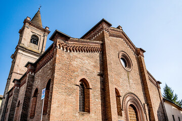 Fototapeta na wymiar The façade of the church of Santa Croce (Holy Cross), built in the 15th century in Gothic style, in the town center of Fontanellato, province of Parma, Italy