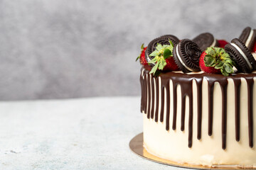 Chocolate cake. Liquid chocolate and strawberry birthday cake on gray background