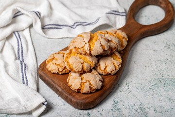 Orange cookies. Cracked delicious cookies on wood serving board