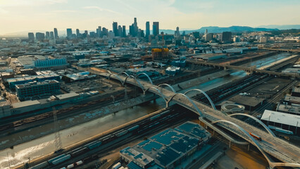 View of Los Angeles skyline with modern bridges and urban infrastructure during late afternoon...