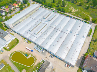 Aerial view of the logistics park with warehouse, loading hub and many semi trucks with cargo...