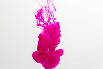 Close up of pink ink in water with copy space on white background