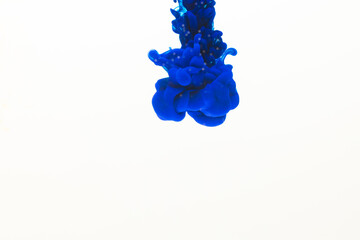 Close up of blue ink in water with copy space on white background
