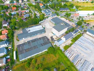 Aerial view of the logistics park with warehouse, loading hub and many semi trucks with cargo...