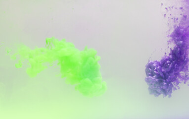 Close up of green and purple ink in water with copy space on white background