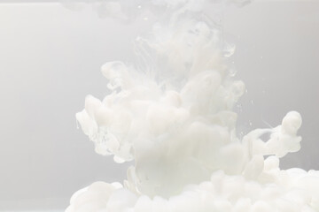 Close up of white ink in water with copy space on white background