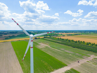 Panoramic view of wind farm or wind park, with high wind turbines for generation electricity with...