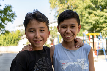 best friends in Uzbekistan enjoying there summer vacation in an outdoor park  playing games and the different expressions on their faces while playing in hot street make a friendship day special 
