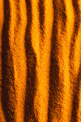 Close up of pattern of orange sand and copy space background