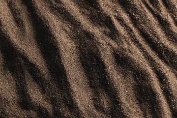 Close up of pattern of brown sand and copy space background