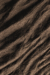 Close up of pattern of brown sand and copy space background
