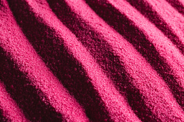 Obraz na płótnie Canvas Close up of pattern of pink sand and copy space background