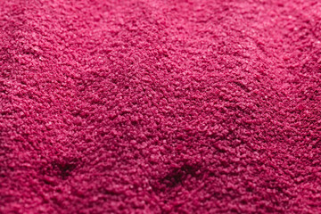 Close up of grains of pink sand and copy space background