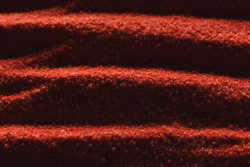 Close up of pattern of red sand and copy space background