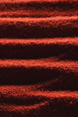 Close up of pattern of red sand and copy space background