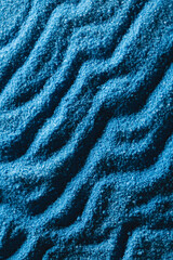 Obraz na płótnie Canvas Close up of pattern of blue sand and copy space background