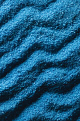 Fototapeta na wymiar Close up of pattern of blue sand and copy space background