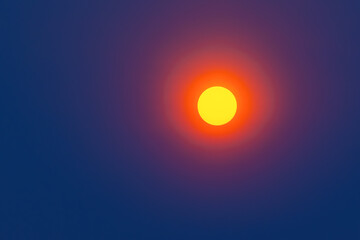 Big red sun in a dark blue sky. The big red sun at sunset background.