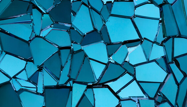 Broken blue glass mosaic. Blue shards background. Broken mirror close-up. Background from shattered blue