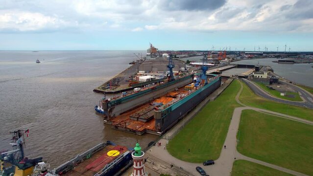 Bremerhaven - ship dock is pulled by the deep-sea tugboat - an aerial view with the drone over the seaport lock
