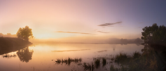 Fototapeta na wymiar Misty lake at sunrise