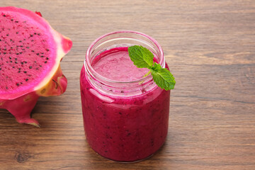 Delicious dragon fruit or pitahaya smoothie and fresh fruits with mint leaves
