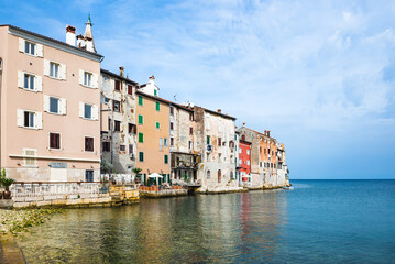 Beautiful Rovinj houses built right on the edge of the sea on the rocky peninsula above water
