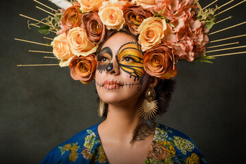 Portrait of a woman with sugar skull makeup. Catrina with butterfly painted on her face. Halloween and day of the dead makeup. - obrazy, fototapety, plakaty