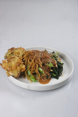 Pecel Mie or Bakmie Pecel is Javanese Salad Made of Mixed Vegetables and Fried Noodle with Peanut Sauce and Gorengan.
