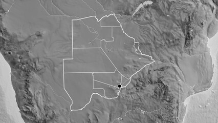 Shape of Botswana with regional borders. Grayscale.