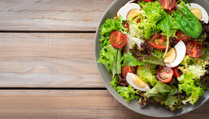 Fresh healthy salad on wooden table. View from above with copy space