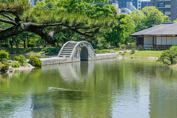 Concrete bridge over man made lake in Shukkeien gardens in Hiroshima.