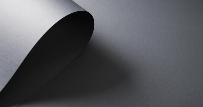 Close up of roll of black paper and copy space on black background